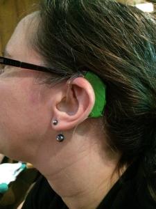 This gorgeous green hearing aid is worn by @LivingArtist on Twitter.