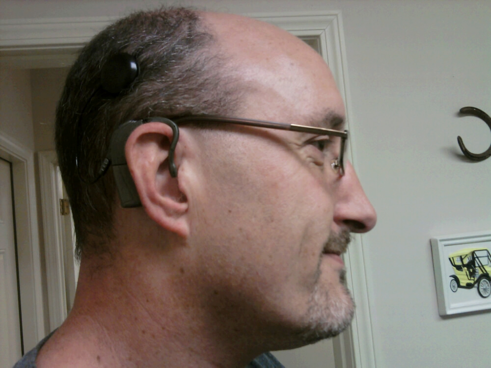 Proudly wearing a cochlear implant, Chris Kurz is the technology innovations coordinator at sComm, developer of the UbiDuo device for the Deaf and hard of hearing. Lipreading Mom is honored to use the UbiDuo at home and will blog about her experiences soon.